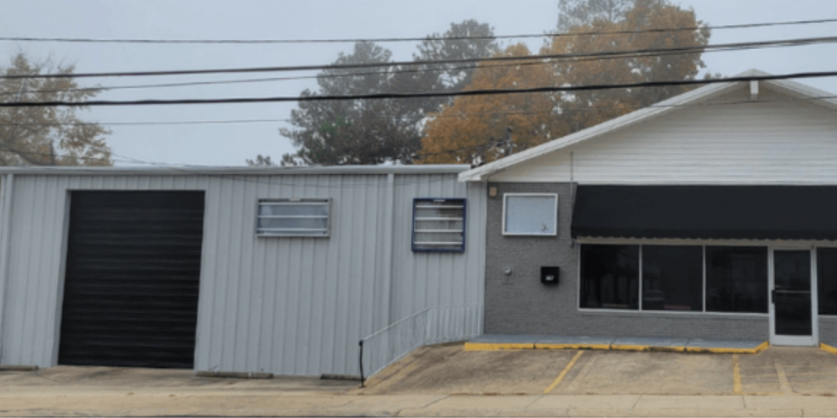 renovated commercial building with fresh paint/black awning the exterior looks clean
