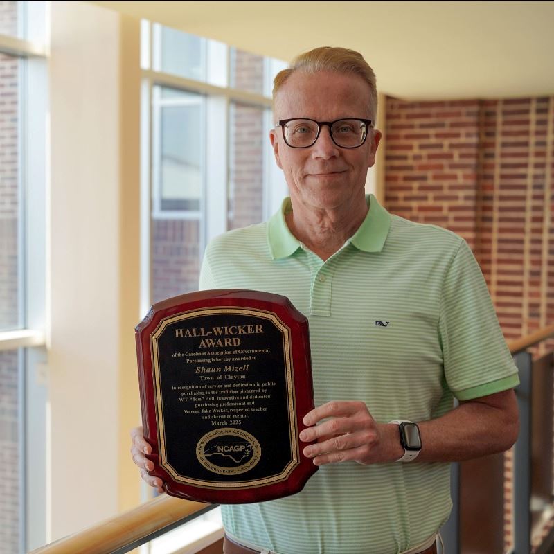 Shaun Mizell holds 2025 Hall-Wicker Award at Town Hall