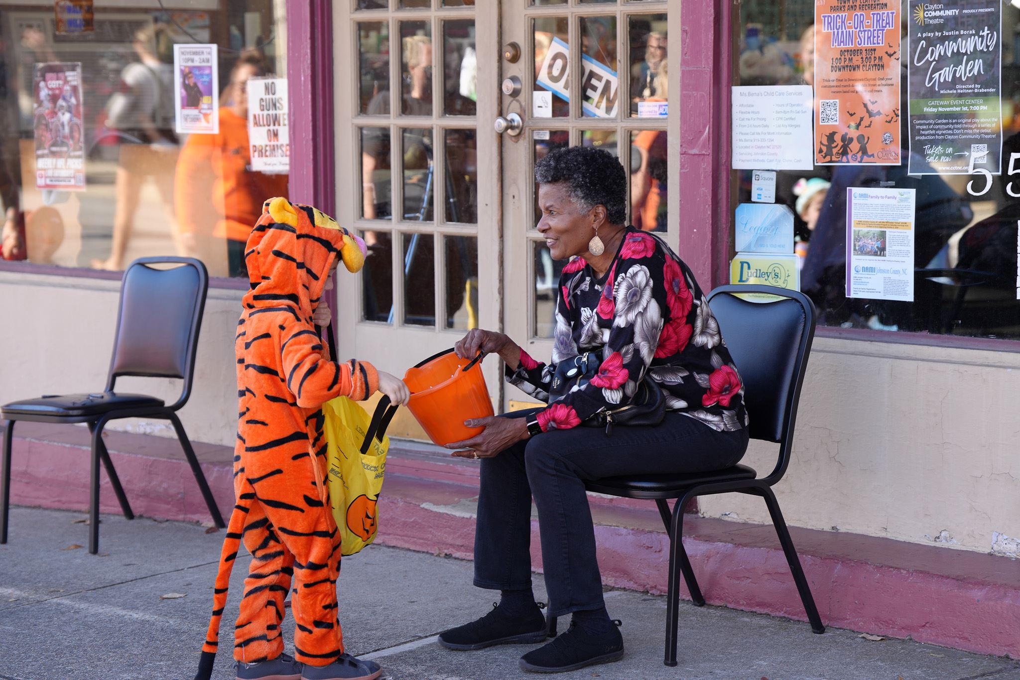 Kids in costumes collect candy during Trick-or-Treat Main Street 
