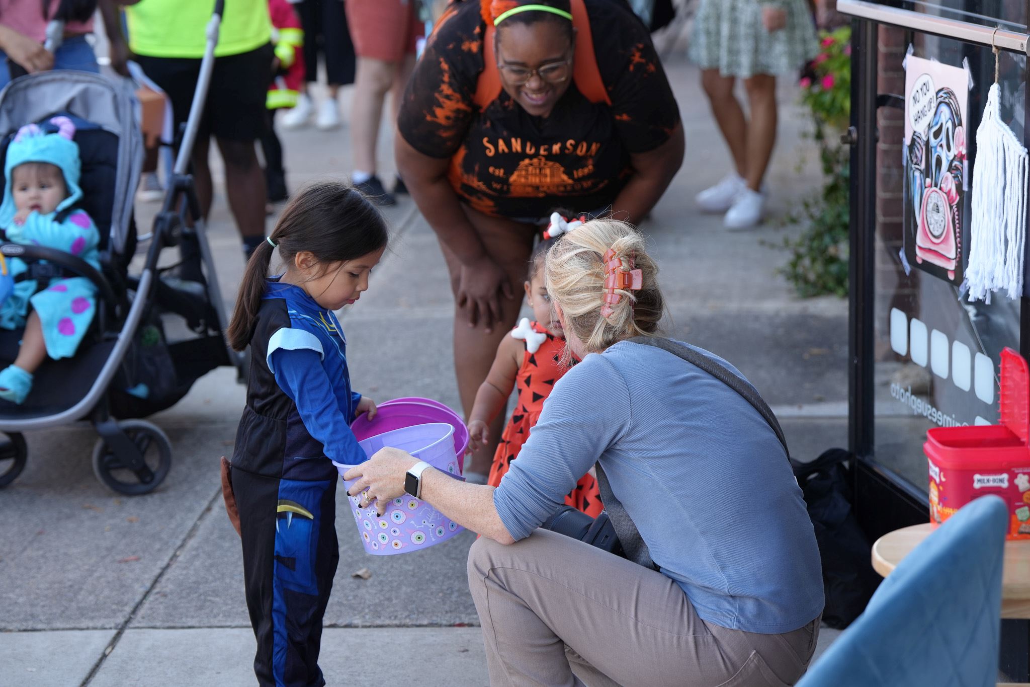 Kids in costumes collect candy during Trick-or-Treat Main Street 