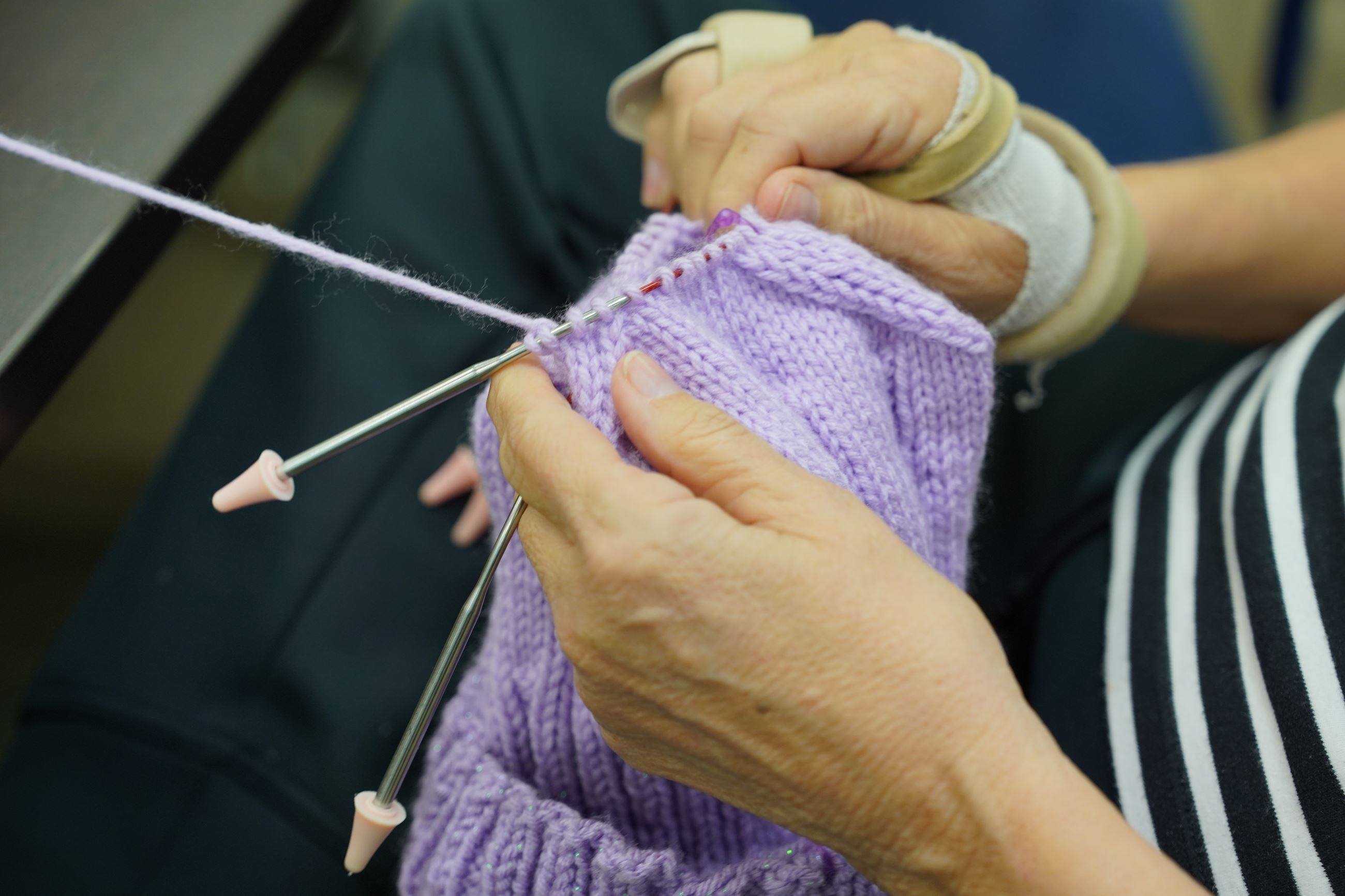 Knit Night attendee works on project