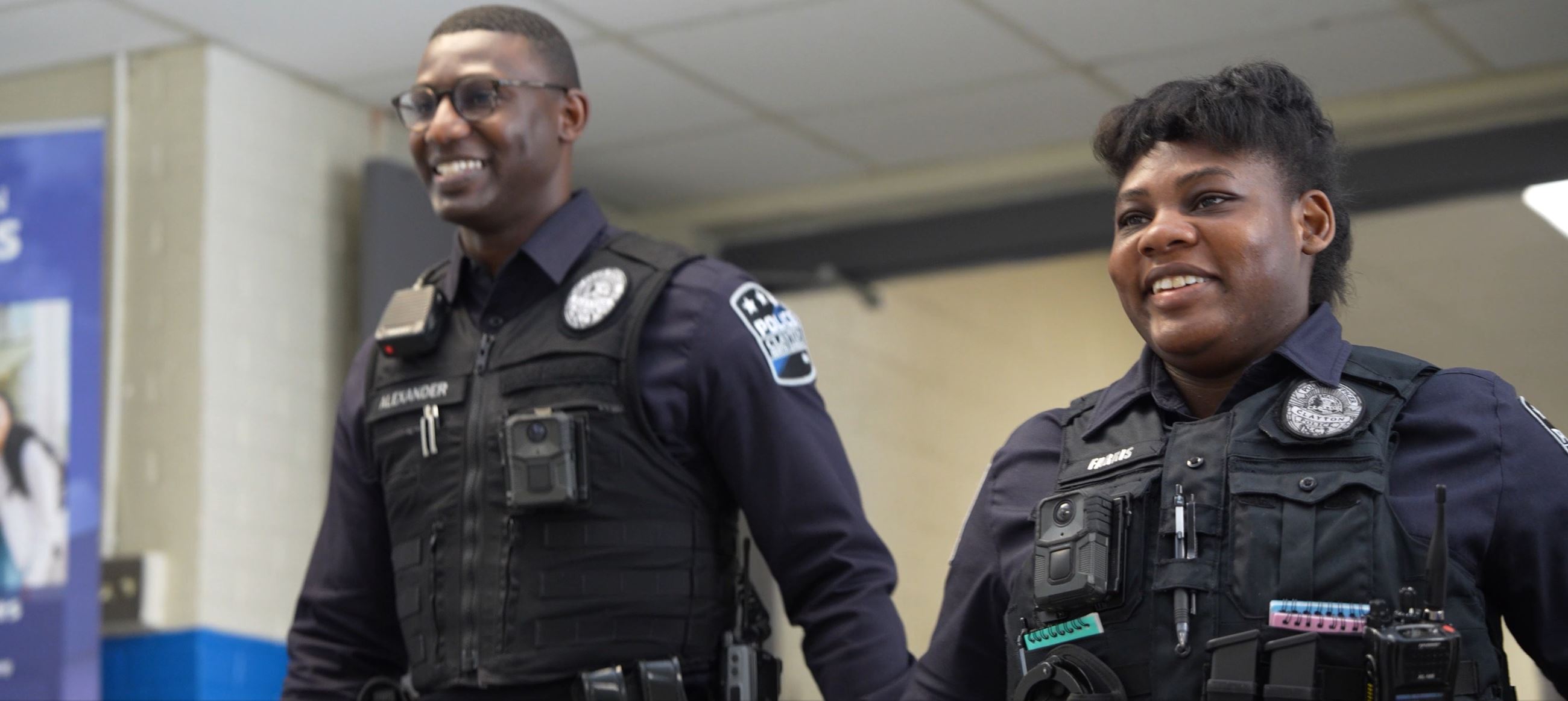 Officer Jamel Alexander (left) and Officer Jalise Farris (right) walking the halls of Clayton High S
