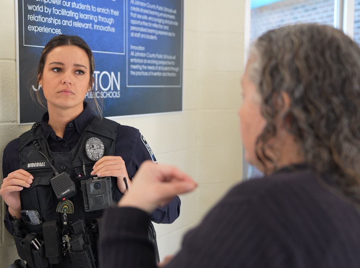 Officer Alexandria Woodall speaking with a staff member at West Clayton Elementary School