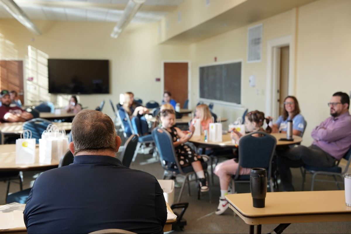 Kids listen to HR rep discuss the town's HR department