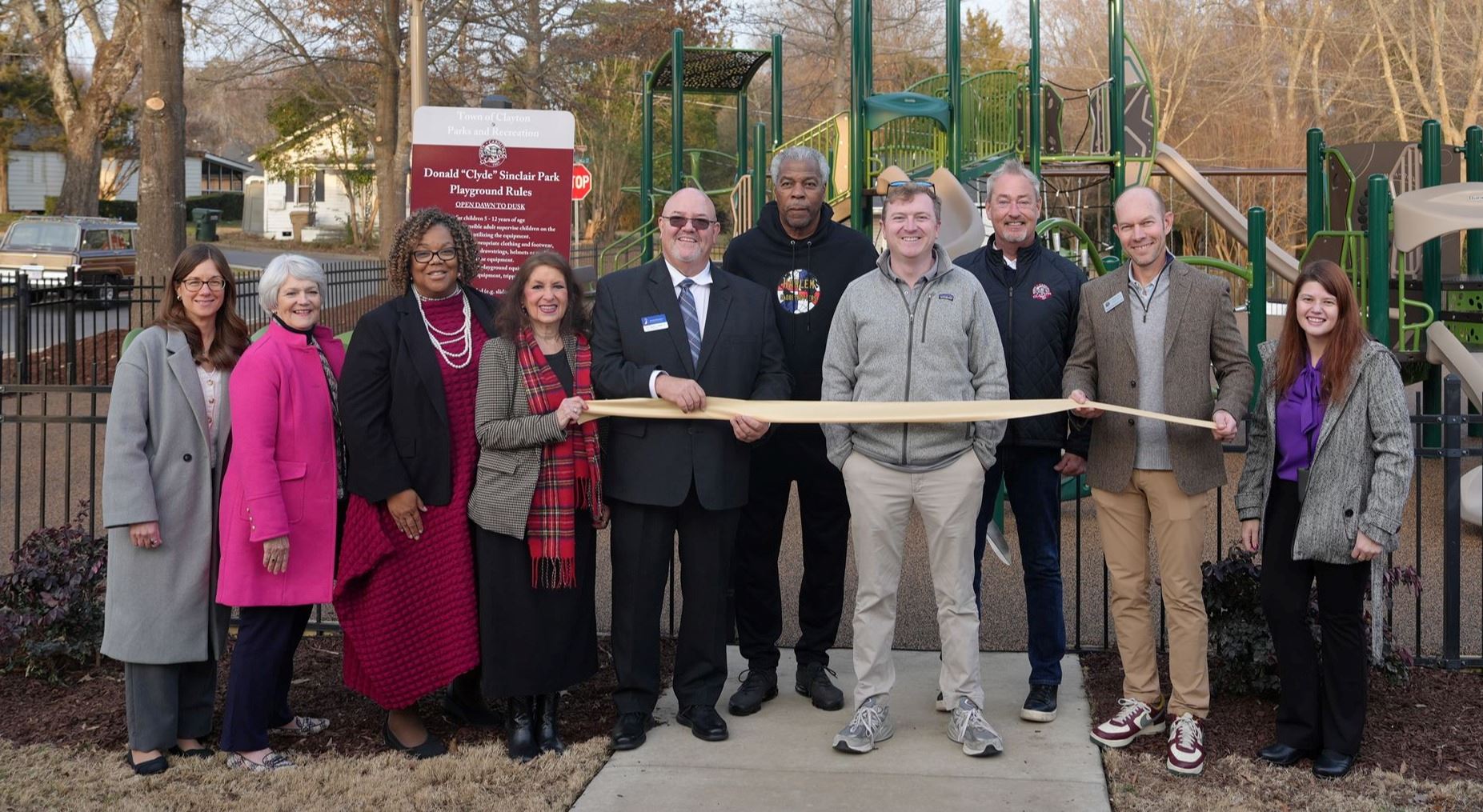 Clayton Council members and other stakeholders prepare to cut ribbon in front of playground